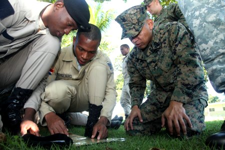 US Navy 111110-A-IP644-184 Hospital Corpsman 3rd Class Jorge Juarez exchanges basic land navigation techniques with Dominican marines