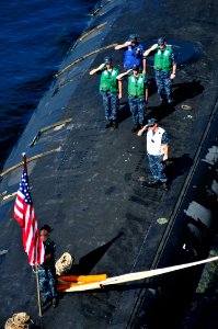 US Navy 111110-N-JH293-141 Sailors aboard the Virginia-class submarine USS Texas (SSN 775) salute the national ensign during the shifting of color