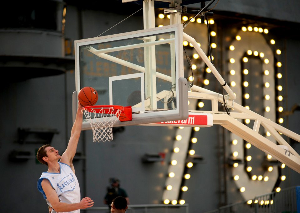 US Navy 111110-N-DR144-460 University of North Carolina basketball player Tyler Zeller dunks during a practice in the basketball arena on the fligh