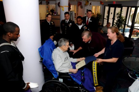 US Navy 111110-N-MZ294-031 Jeff Chapin, a veteran volunteer, presents Walter Walz, a a World War II Marine Corps veteran in hospice care, with a l