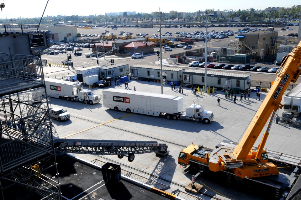 US Navy 111108-N-RG587-105 ESPN trucks arrive with broadcasting equipment as workers construct a basketball arena aboard the Nimitz-class aircraft