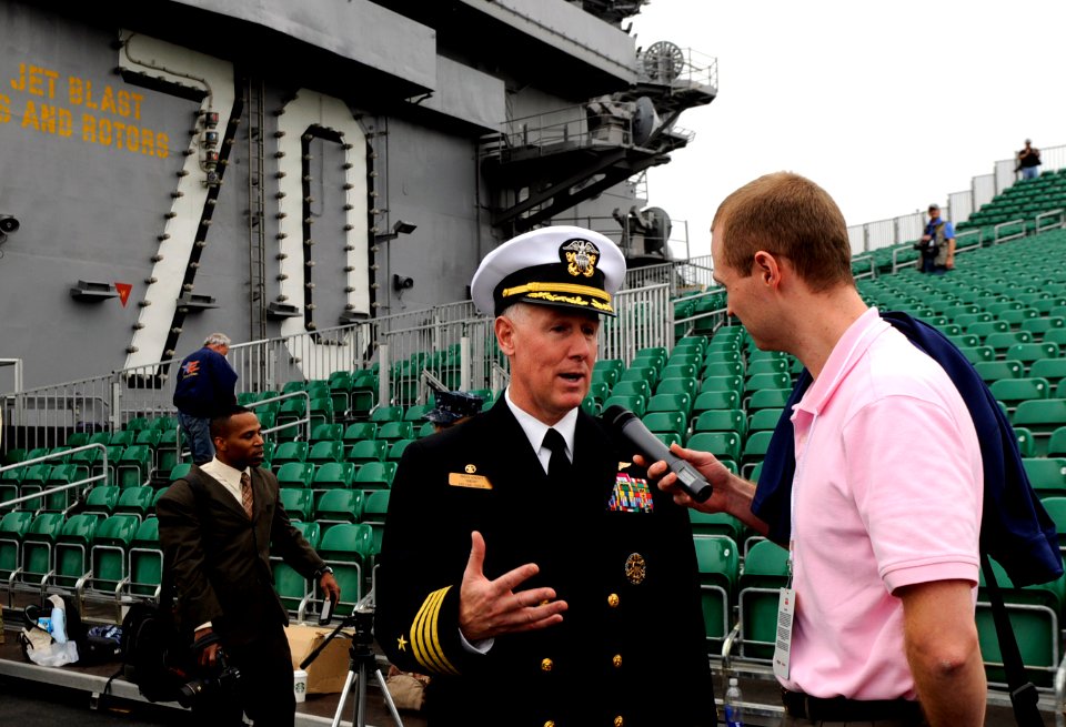 US Navy 111110-N-GZ277-308 Capt. Bruce H. Lindsey, left, commanding officer of the aircraft carrier USS Carl Vinson (CVN 70), speaks with media on