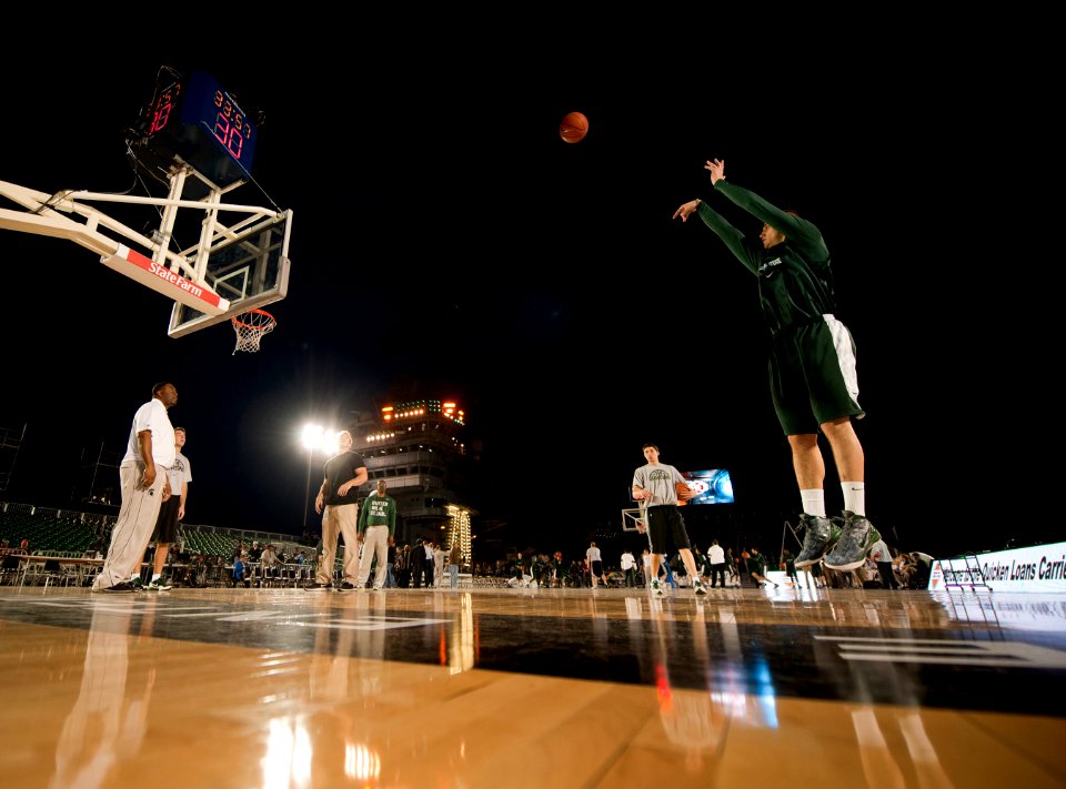 US Navy 111110-N-DR144-848 Michigan State University basketball player Alex Gauna shoots during a practice in the basketball arena on the flight de