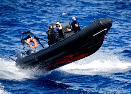 US Navy 111110-N-RI884-033 A rigid-hulled inflatable boat approaches the guided-missile destroyer USS O'Kane (DDG 77) photo