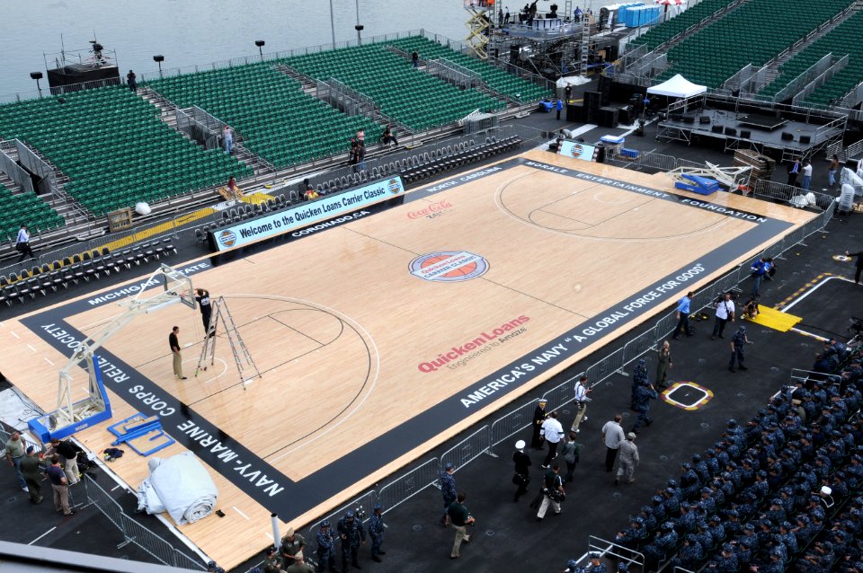 US Navy 111110-N-RG587-020 Officials measure the basket as Sailors fill the stands in the basketball arena on the flight deck of the Nimitz-class a