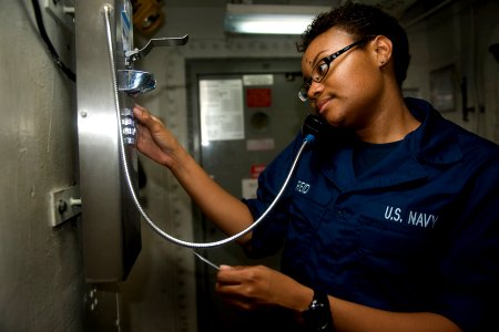 US Navy 111109-N-RJ456-051 A Sailor dials home on one of the ship's Sailor lines