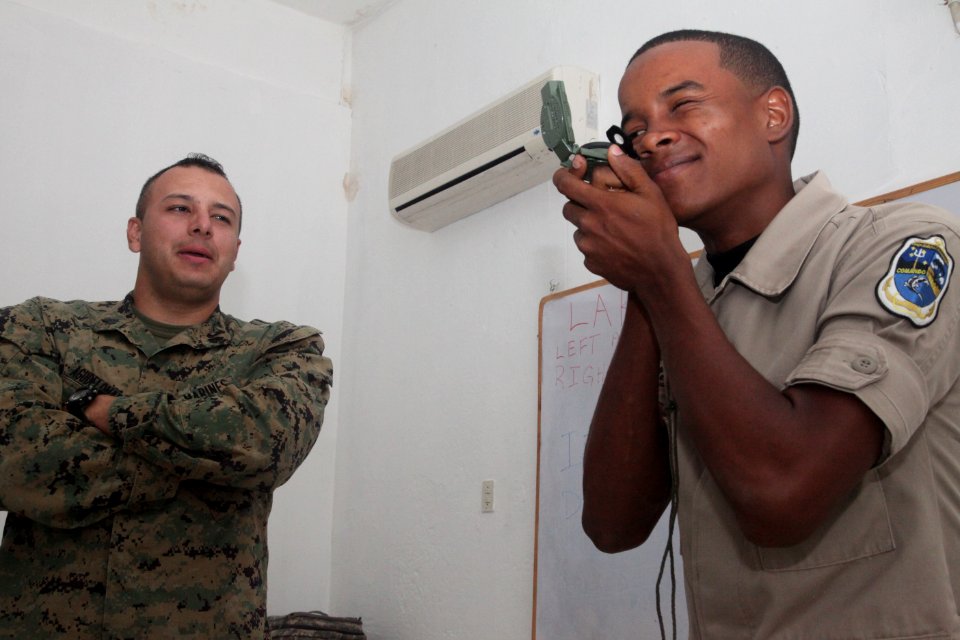 US Navy 111110-A-IP644-007 Sgt. Jhonny Agudello observes a Dominican marine use the