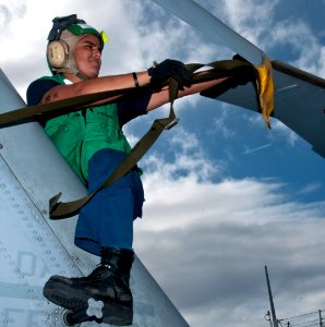 US Navy 111110-N-WX059-029 Aviation Machinist Mate 3rd Class Eduardo Luna works on an SH-60B Sea Hawk helicopter aboard the guided-missile destroy