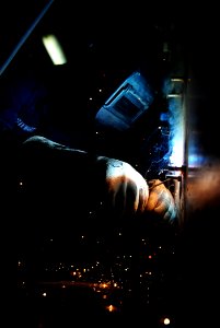 US Navy 111111-N-QL471-230 Hull Maintenance Technician 3rd Class Andrew T. Stewart welds bolts to a bulkhead aboard the aircraft carrier USS George