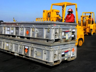 US Navy 111112-N-YC505-123 A Sailor moves ordnance on flight deck