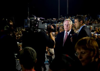 US Navy 111111-N-AC887-006 Secretary of the Navy (SECNAV) the Honorable Ray Mabus conducts a courtside interview with ESPN sports broadcaster Andy