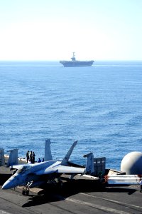 US Navy 111112-N-QL471-089 Two carriers conduct a vertical replenishment