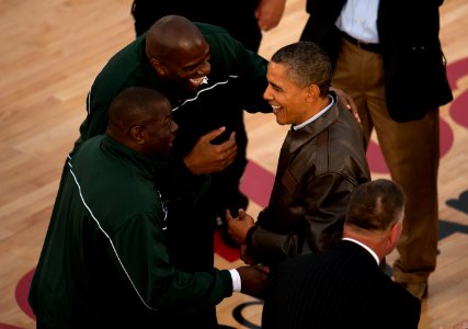 US Navy 111111-N-DR144-701 President Barack Obama, left, is greeted on the court by NBA Hall of Fame basketball player Earvin