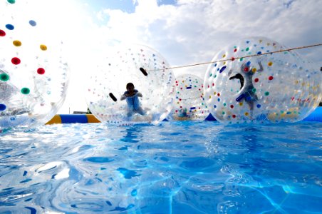 US Navy 111113-N-WJ771-175 Children play inside water balls during the White Beach Festival, a two-day, open-base event sponsored by Commander, Fle photo