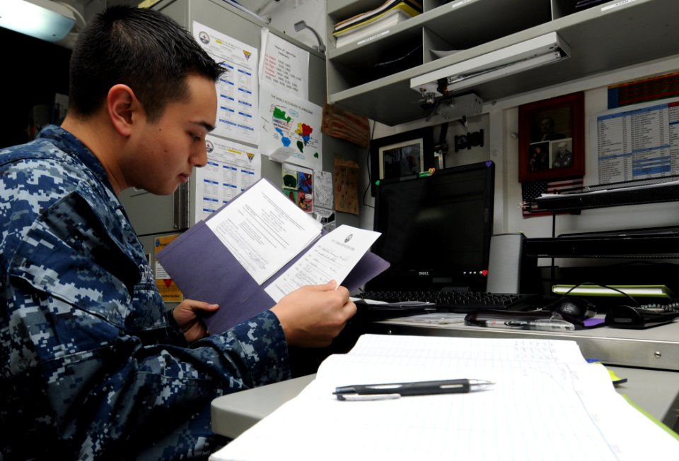 US Navy 111111-N-YC505-021 Aviation Maintenance Administrationman Airman Leo G. Greene reviews request forms in the aircraft intermediate maintenan