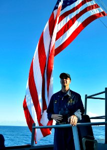 US Navy 111115-N-RI884-100 Cmdr. Michael Ray, commanding officer of the guided-missile destroyer USS O'Kane (DDG 77), observes gunnery exercises du