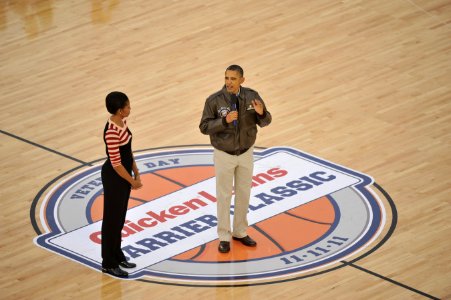 US Navy 111111-N-DR144-322 President Barack Obama and first lady Michelle Obama address attendees at the inaugural Quicken Loans Carrier Classic b photo