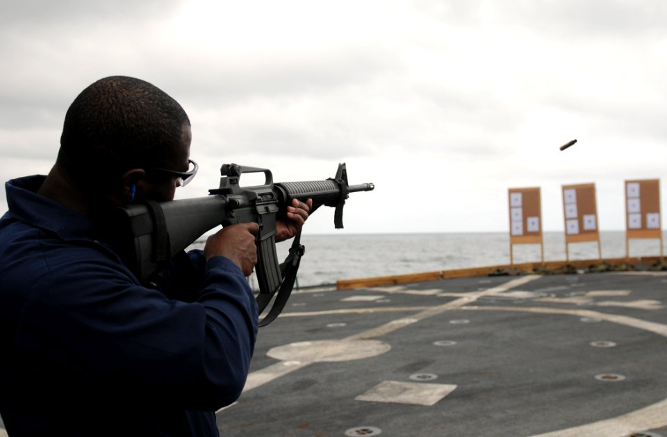 US Navy 111112-N-XQ375-141 Chief Fire Controlman Frank Phillips fires an M16 rifle during a weapons qualification aboard the guided-missile destroy