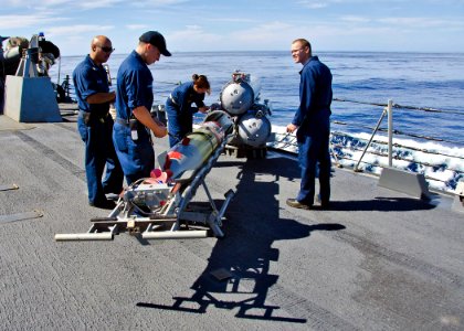 US Navy 111115-N-RI884-254 Sailors aboard the guided-missile destroyer USS O'Kane (DDG 77) load a MK 46 Mod 5A exercise torpedo during the integrat photo