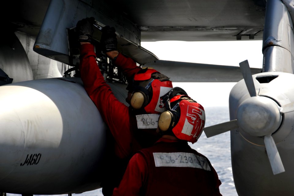 US Navy 111115-N-SF704-105 Aviation Ordnancemen attached to the Gauntlets of Electronic Attack Squadron 136 inspect the bomb rack of an EA-6B Prowl