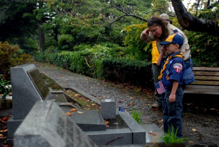 US Navy 111111-N-MU720-019 A scout and his mother from Boy Scouts Troop 35 Yokosuka, render honors after placing an American flag on the gravesite