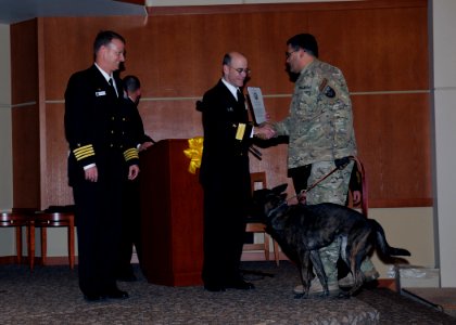 US Navy 111114-N-AE328-047 Rear Adm. Douglass Biesel, commander of Navy Region Northwest, presents a thank you letter to a returning Individual Au