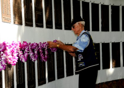 US Navy 111111-N-UK333-050 Retired Submarine veteran Yeoman 1st Class Al Shoehigh places a lei on the plaque