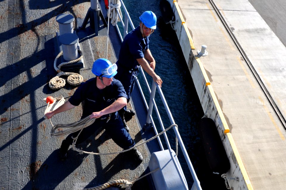 US Navy 111113-N-YX169-069 Seaman Recruit Johannes Hanselmann throws a heaving line from the forcastle of the amphibious transport dock ship USS Po