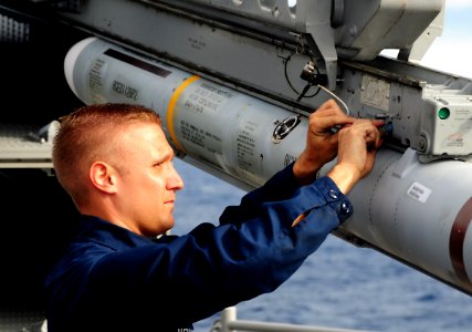 US Navy 111117-N-FH966-583 A Sailor installs wire on a Sea Sparrow missile