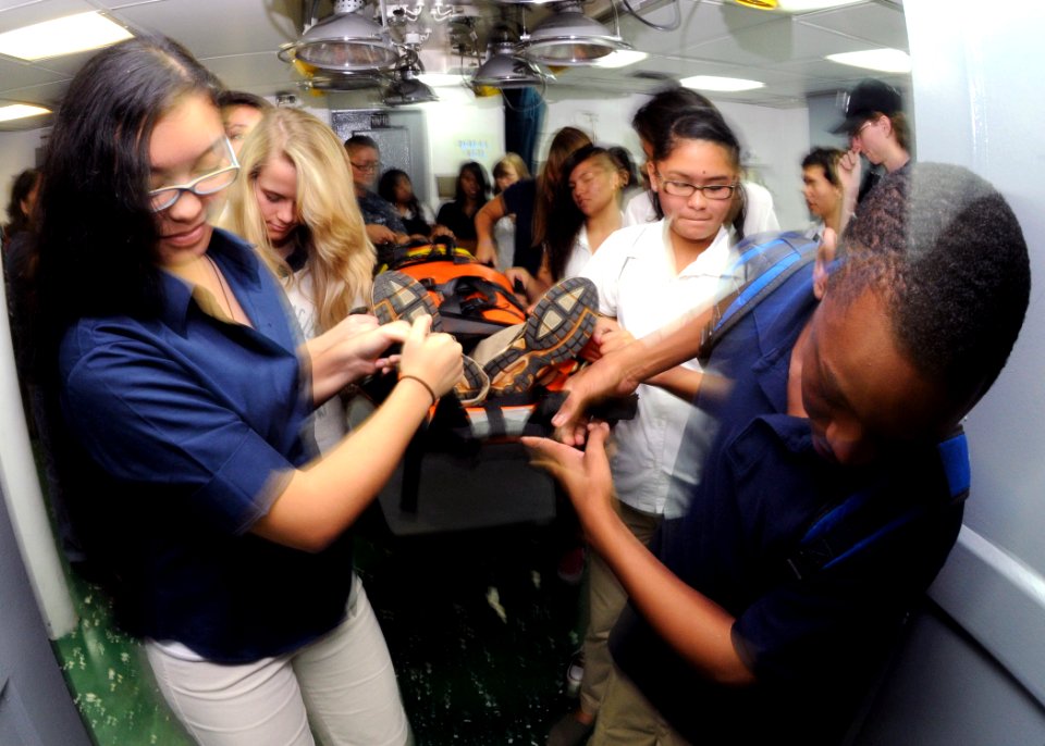 US Navy 111117-N-BK435-120 Hospital Corpsman 2nd Class Victoria Lord carry a classmate in a stretcher through the medical department during a ship