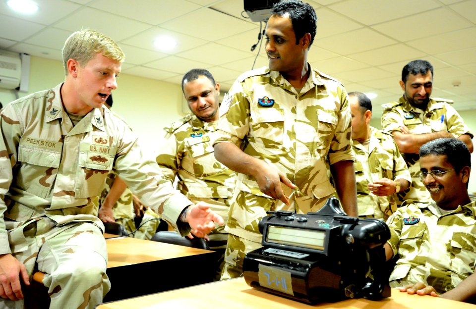 US Navy 111115-N-RP435-143 Explosive Ordnance Disposal 1st Class Carey Peekstock shows Royal Bahrain Army explosive ordnance technicians a handheld