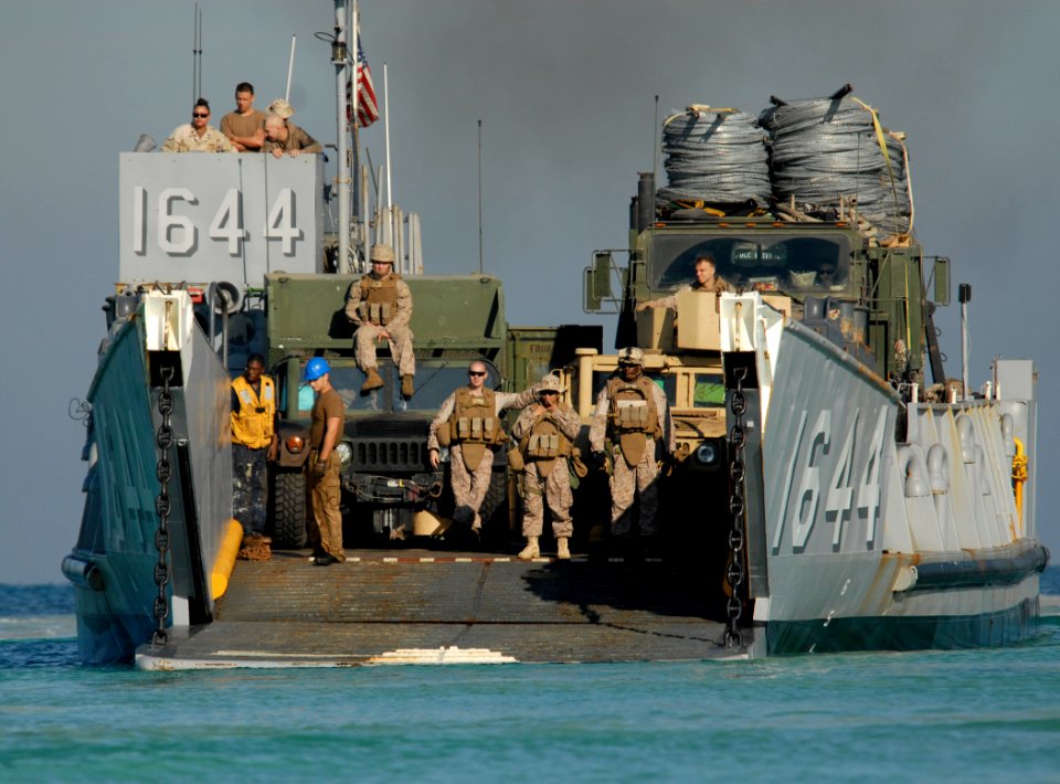 US Navy 111114-N-KA046-056 Sailors and Marines disembark from a landing craft utility (LCU) assigned to the amphibious dock landing ship USS Whidb