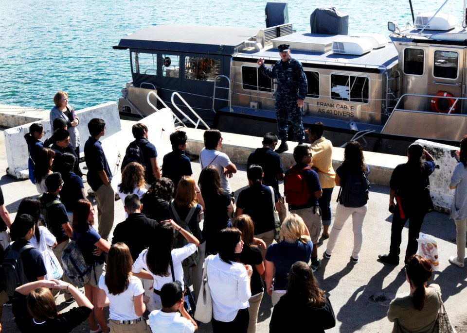 US Navy 111116-N-BK435-009 A Sailor shows a dive boat to students from the Guam High School