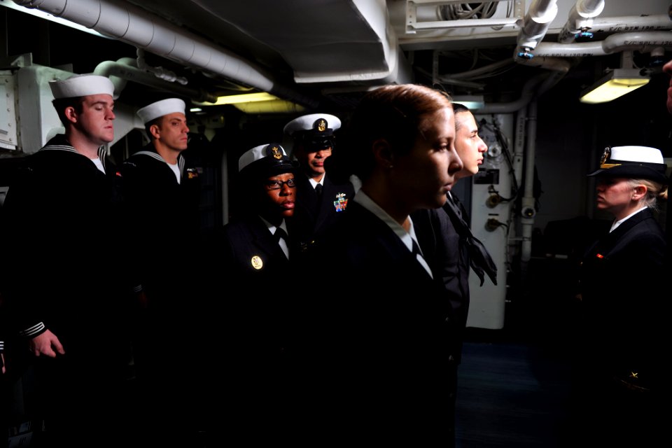US Navy 111117-N-YZ751-016 Command Master Chief Paulette Brock inspects the back of Sailors' uniforms during a dress blues inspection aboard the gu