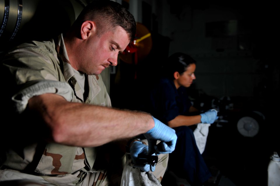 US Navy 111115-N-YZ751-209 Gas Turbine System Technician (Mechanical) 1st Class William Tillotson, left, and Gunner's Mate 2nd Class Valerie Rodrig