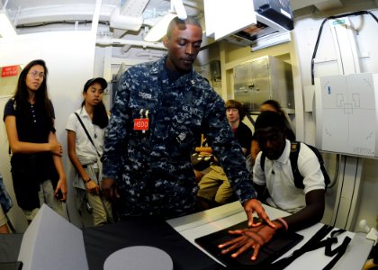 US Navy 111117-N-BK435-010 Hospital Corpsman 2nd Class Andre Cooper demonstrates to the students from Guam High School's Health Team Dynamic's clas