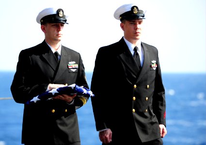 US Navy 111117-N-QL471-171 Senior Chief Machinist's Mate Kenneth W. Decker bears the national ensign while accompanied by Chief Machinist's Mate Da