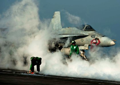 US Navy 111119-N-BT887-201 Sailors reset a steam-powered catapult as an F-A-18C Hornet assigned to the Golden Dragons of Strike Fighter Squadron (