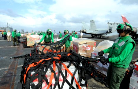 US Navy 111117-N-JO245-114 Logistics specialists aboard the nuclear-powered aircraft carrier USS George Washington (CVN 73) remove cargo nets