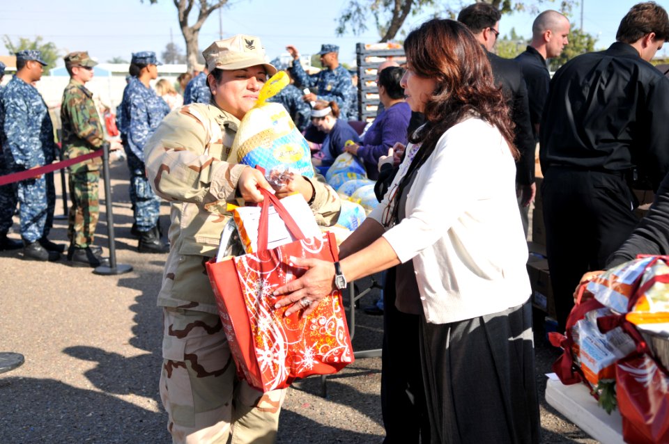 US Navy 111117-N-UD469-395 egalman 2nd Class Alexandra Erwin receives her Thanksgiving meal from the vendors of the Navy Commissary in Imperial Bea