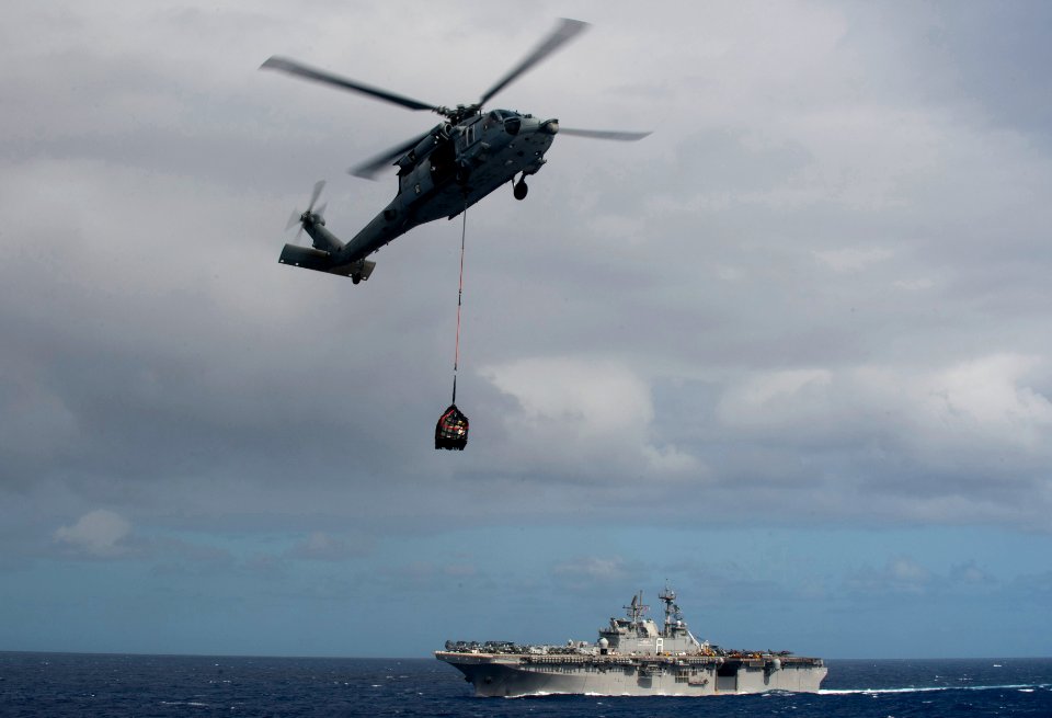 US Navy 111119-N-PB383-694 An MH-60 Sea Hawk helicopter assigned to Helicopter Sea Combat Squadron (HSC) 23 delivers supplies from the amphibious a
