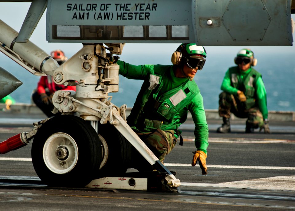 US Navy 111120-N-BT887-062 Aviation Boatswain's Mate (Equipment) Airman Manolito Recto looks for the signal to advance an F-A-18F Super Hornet assi