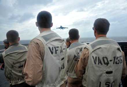 US Navy 111115-N-SF704-256 Landing signal officers aboard the Nimitz-class aircraft carrier USS George Washington observe an EA-6B Prowler as it fl