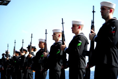 US Navy 111117-N-QL471-125 Members of the honor guard aboard the aircraft carrier USS George H.W. Bush render honors during a burial at sea ceremon photo