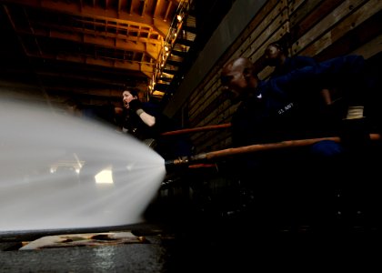 US Navy 111121-N-WJ771-078 Sailors man a fire hose during a crash and salvage drill photo