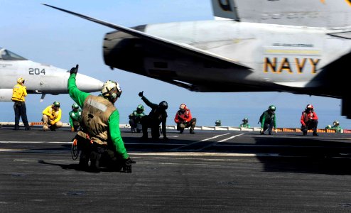 US Navy 111119-N-OY799-126 Final checkers signal clear to launch as an F-A-18C Hornet assigned to the Warhawks of Strike Fighter Squadron (VFA) 97