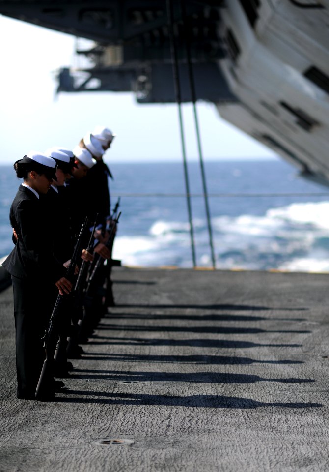 US Navy 111117-N-XE109-074 Members of the honor guard aboard the aircraft carrier USS George H.W. Bush bow their heads in prayer during a burial at
