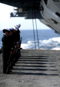 US Navy 111117-N-XE109-074 Members of the honor guard aboard the aircraft carrier USS George H.W. Bush bow their heads in prayer during a burial at