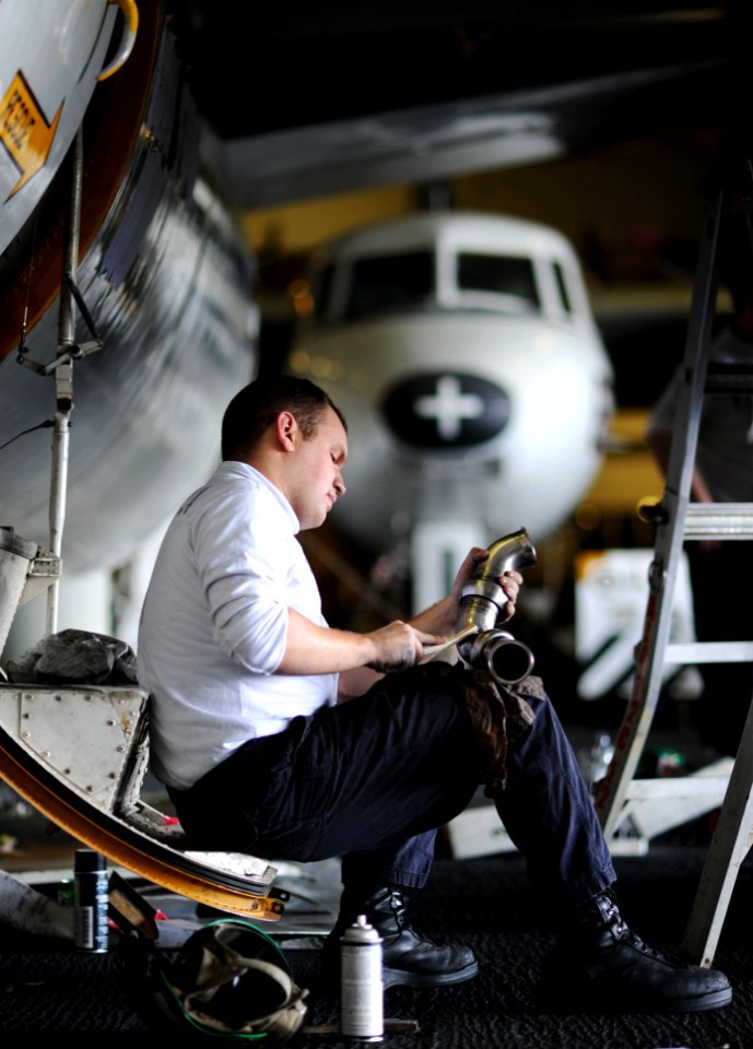 US Navy 111119-N-XE109-048 Sailor performs maintenance on aircraft part