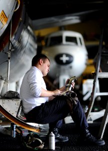US Navy 111119-N-XE109-048 Sailor performs maintenance on aircraft part